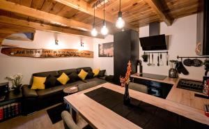 a living room with a couch and a table at Forest Escape with Jacuzzi & Pool Among the Trees by Destination GREEN Croatia in Ivanec