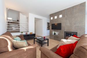 un salon avec deux canapés et une cheminée dans l'établissement Townhouse Ocean Joy by Algarve Vacation, à Albufeira