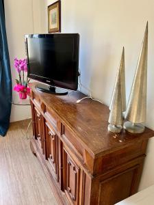 a flat screen tv sitting on top of a wooden dresser at Angelo ai Musei Vaticani bilocale in Rome