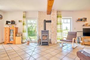 a living room with a wood burning stove in it at Am Redensee in Fuhlendorf