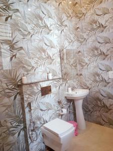 a bathroom with a toilet and a sink at Anand Kunj in Chandīgarh