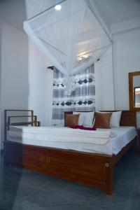 a large bed with a canopy in a room at Ella Woodland 3 Arch Cottage in Ella