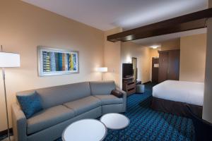 a hotel room with a couch and a bed at Fairfield Inn & Suites by Marriott Houma Southeast in Houma +17 photos
