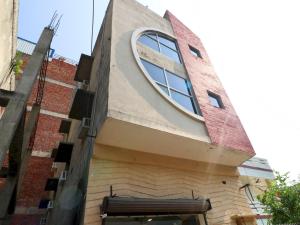 a building with a round window on the side of it at Hotel O Mall Residency in Amritsar +24 photos