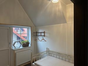a small bedroom with a bed and a window at D&R Apartments in Mažeikiai