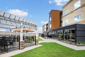 an exterior view of a building with a patio and grass at Fairfield Inn & Suites by Marriott Van in Van