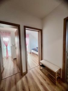 an empty room with a mirror and a bench at Apartmán Roda2 Malé Lipno in Černá v Pošumaví