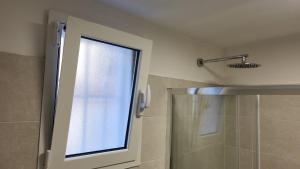 a bathroom with a shower with a glass door at Al Duomo "via Mazzocchi" in Santa Maria Capua Vetere +29 photos