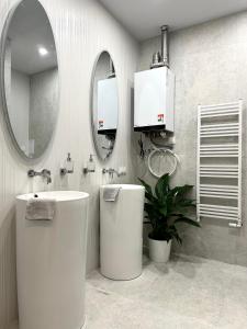 a bathroom with a sink and a toilet and a mirror at Dubois Apartment - Self Check-In 20h in Wrocław