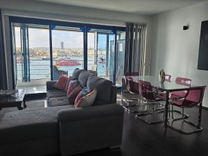 a living room with a couch and a table at Sea View over Valletta Harbour 3 bedrooms 2 S4 in Sliema