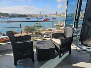 a balcony with a table and chairs and a view of the water at Sea View over Valletta Harbour 3 bedrooms 2 S4 in Sliema