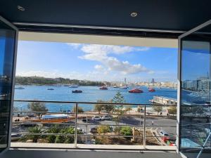 a view of a river from a window in a building at Sea View over Valletta Harbour 3 bedrooms 2 S4 in Sliema