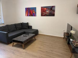 a living room with a couch and a table at POLAT Apartments 7 in Essen