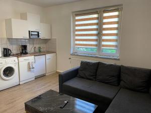 a living room with a couch and a kitchen at POLAT Apartments 7 in Essen +2 photos