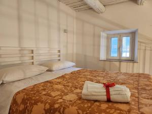 a bedroom with a bed with a red ribbon on it at Al Duomo "via Mazzocchi" in Santa Maria Capua Vetere