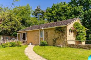 a small brick house in a yard at The Condo Swimming Pool available from May until October only in Broadmayne