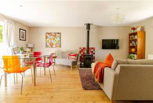 a living room with a couch and a table and chairs at The Condo Swimming Pool available from May until October only in Broadmayne