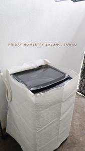 a white container with a cell phone sitting on top of it at Friday Homestay Taman Sawit Balung, Tawau in Tawau