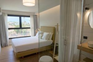 a bedroom with a bed and a glass shower at Casa Carlos in Puerto de la Cruz +45 photos