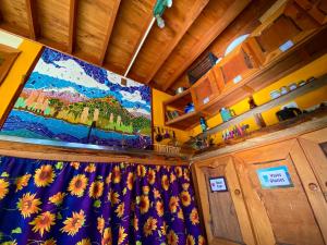 a large window in a room with a painting on the wall at Hostal Las Natalias in Futaleufú