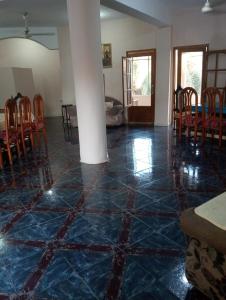 a room with a blue tiled floor with a table and chairs at New Oasis 2 in Bawiti +5 photos