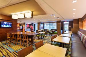 a restaurant with tables and chairs and a couch at Fairfield Inn & Suites by Marriott Johnson City in Johnson City