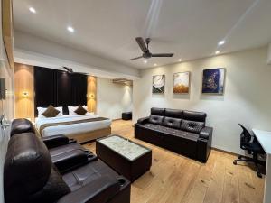 a living room with a bed and a couch at HOTEL TOUCHWOOD in Visakhapatnam
