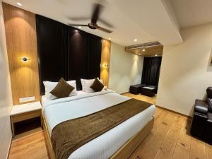 a bedroom with a large bed in a room at HOTEL TOUCHWOOD in Visakhapatnam