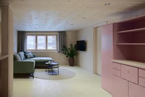 a living room with a couch and a table at Ferienhaus Mell Aroma in Mellau