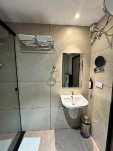 a bathroom with a sink and a shower at HOTEL TOUCHWOOD in Visakhapatnam