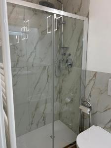 a shower with a glass door in a bathroom at Les Suites di Parma - Cavour in Parma