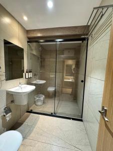 a bathroom with a shower and a sink at HOTEL TOUCHWOOD in Visakhapatnam