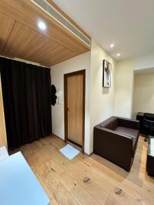 a living room with a couch and a door at HOTEL TOUCHWOOD in Visakhapatnam