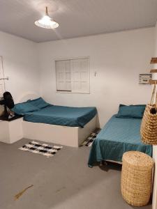 a bedroom with two beds in a room at Casa PE NA AREIA na Praia da Caueira com Piscina e SPA in Praia Da Caueira