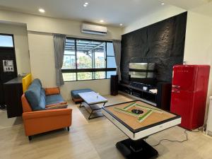 a living room with a red refrigerator and a table at 碧雲香榭羅東包棟民宿 in Luodong
