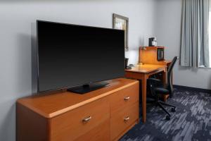a flat screen tv sitting on top of a dresser at Fairfield Inn & Suites by Marriott Wichita Downtown in Wichita