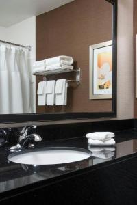 a bathroom with a sink and a mirror and towels at Fairfield Inn & Suites Peru in Peru +12 photos