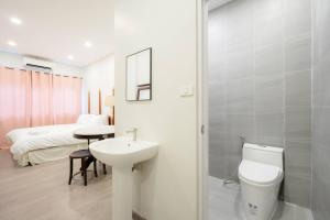 a bathroom with a sink and a toilet and a bed at Hidden Dragon China Town MRT Dragon Temple in Samphanthawong +46 photos