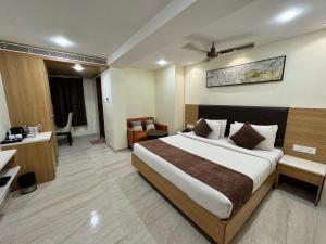 a hotel room with a bed and a desk at HOTEL TOUCHWOOD in Visakhapatnam