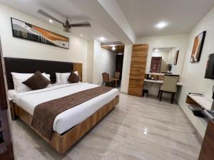 a bedroom with a large bed in a room at HOTEL TOUCHWOOD in Visakhapatnam