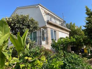 a large house with trees in front of it at Apartment Tulip in Premantura