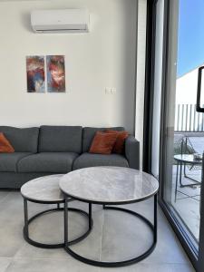 a living room with a couch and a table at Tremythia Homes - Deluxe loft and 2-bed houses in Konia