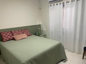 a bedroom with a green bed with two pillows on it at Casa Sinop in Sinop +17 photos