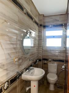a bathroom with a toilet and a sink at Furnished apartment - Madinaty in Madinaty +1 photo