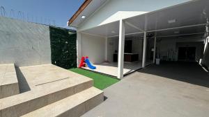 a house with a playground with a red slide at espaço R&H in Macapá