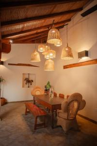 a dining room with a table and chairs and lights at Central Park Luxurious Historical Home With Pool in Granada +86 photos