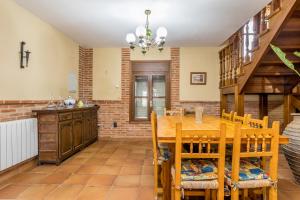 Un comedor con mesa y sillas de madera. en BaruHaus VillaHermosa, en Villamañán 17 fotos más