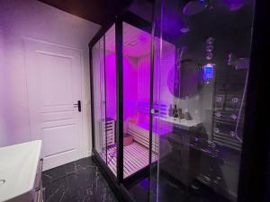 a bathroom with purple lights in a room at Jacuzzi privé, Sauna & Design Chic in Reims +46 photos