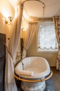a bath tub in a bathroom with a window at Argo Trakai in Trakai