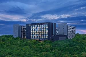 a building on top of a hill with trees at Four Points by Sheraton Balikpapan in Balikpapan +22 photos